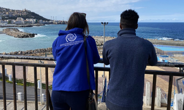 IOM Algeria staff with a migrant at the transit centre in Algiers. ©IOM